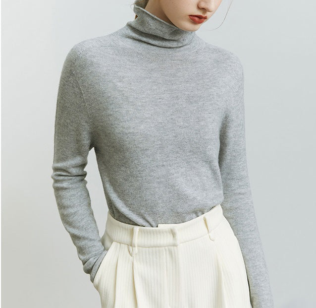 Gray knit turtleneck sweater with stack collar and long sleeves