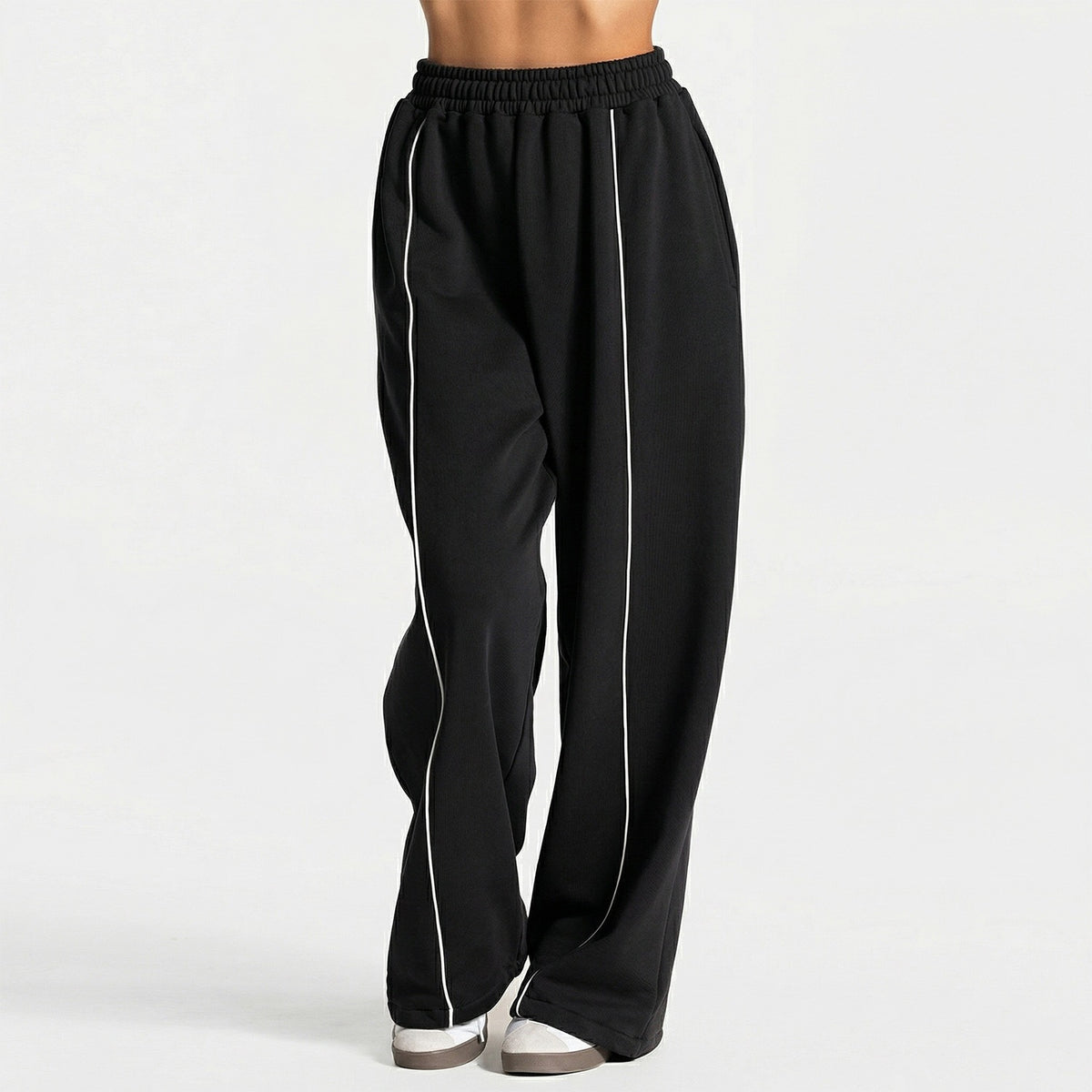 Black loose yoga pants with elastic waistband and vertical white contrast stripe