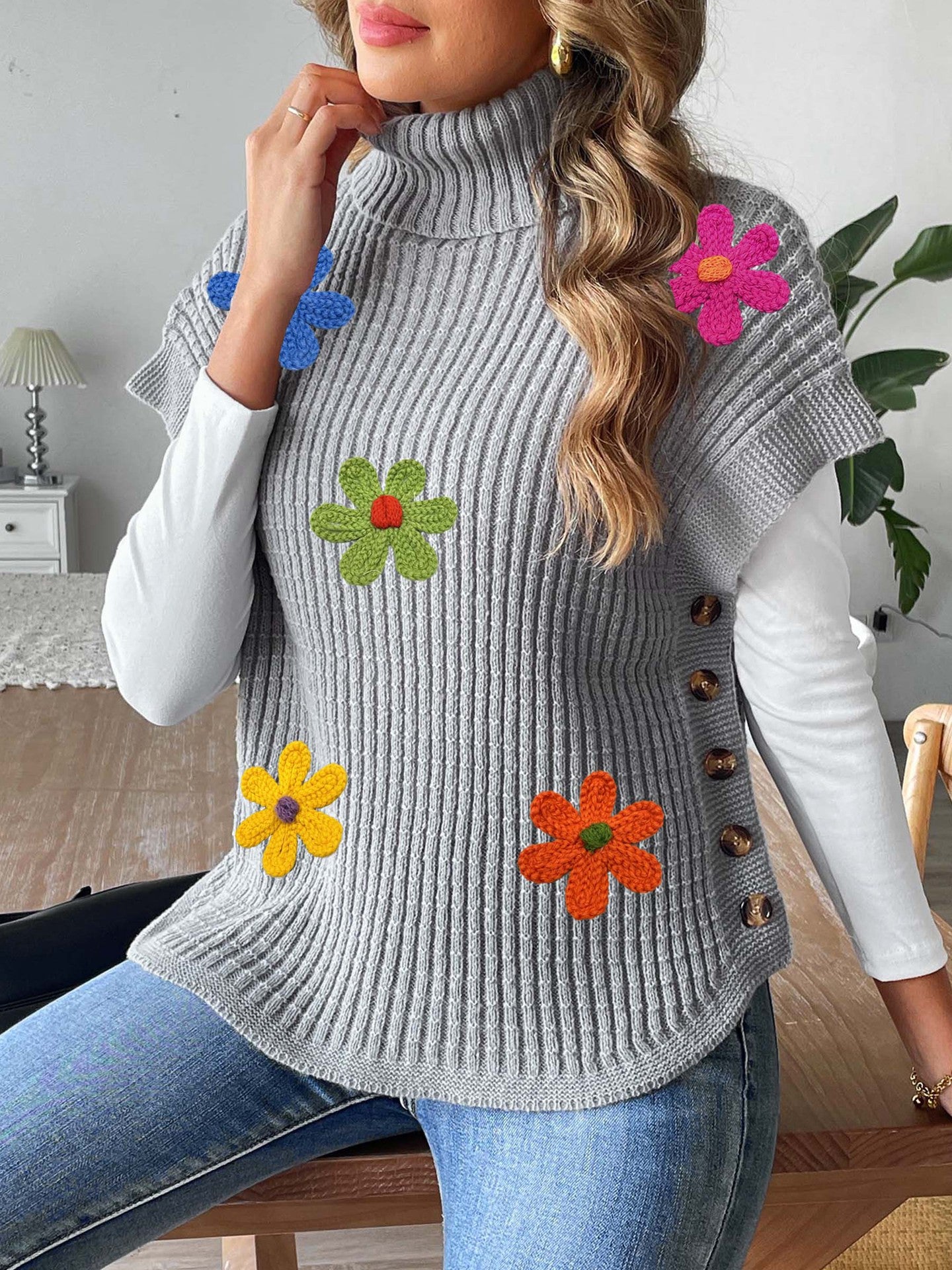 Gray knit high-neck sweater vest with colorful flower appliques and button placket