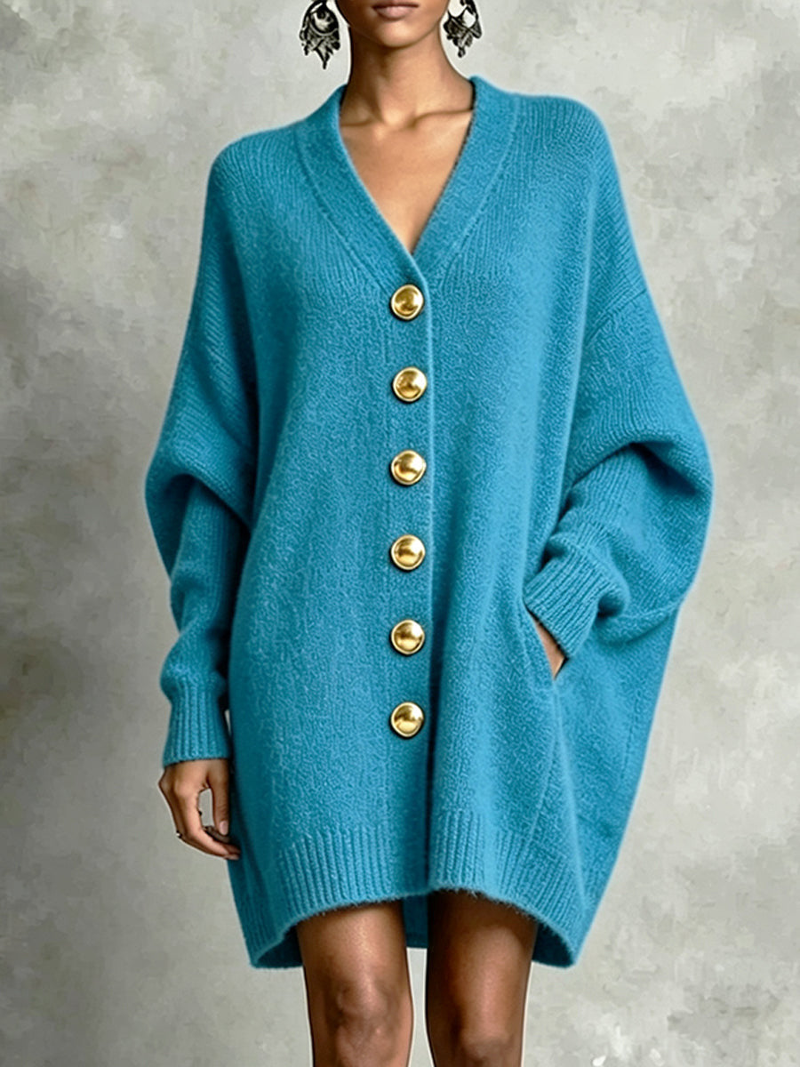 Blue V-neck knit cardigan with gold button front and oversized sleeves