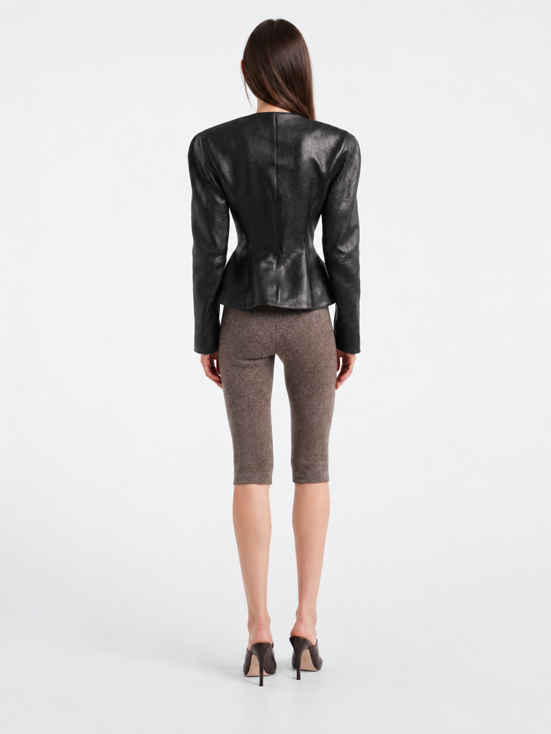 Women’s black leather jacket, back view with slim peplum waist and long sleeves.