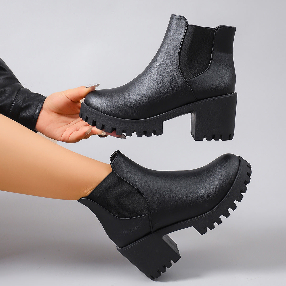 Black leather-look ankle boots with thick tread sole and elastic side gore