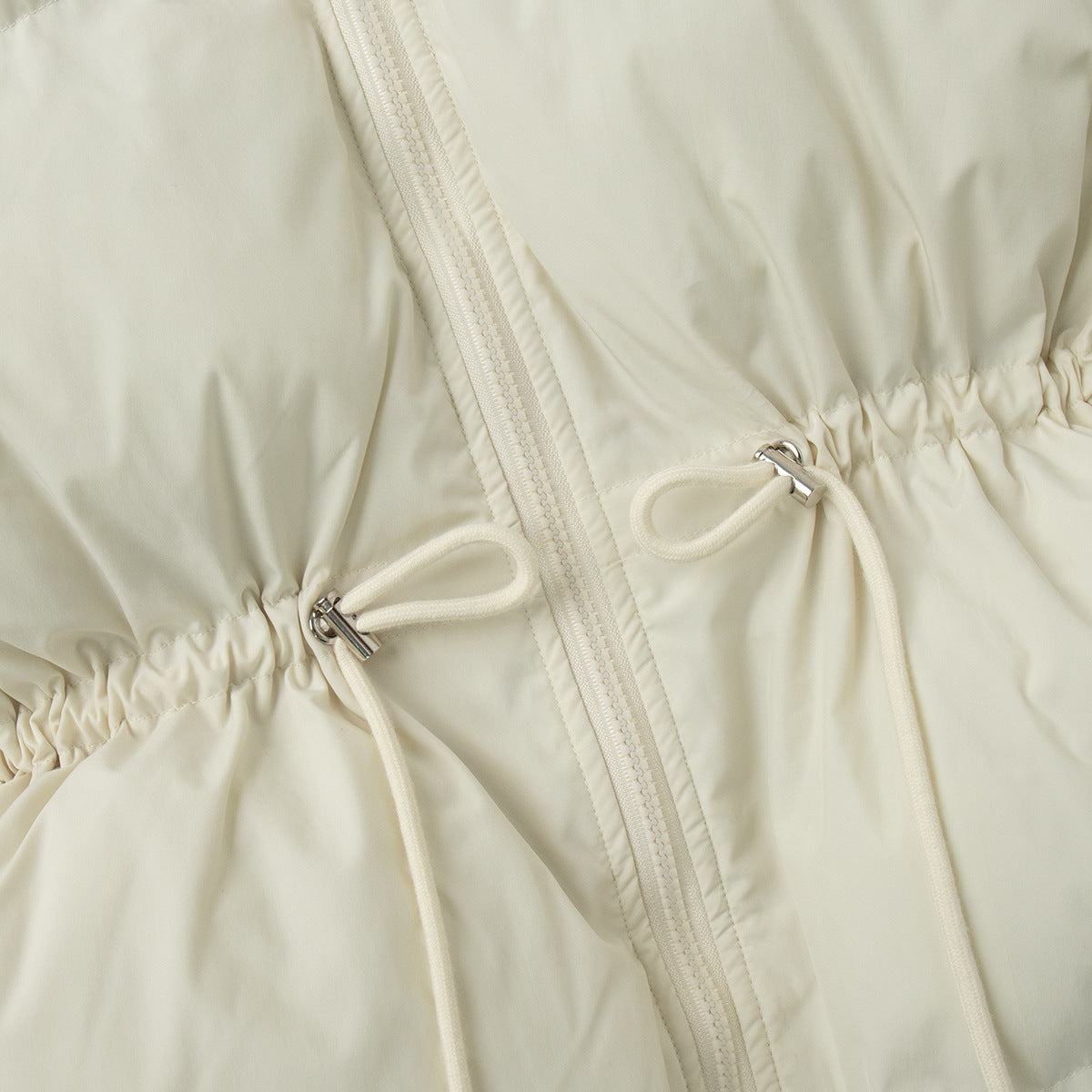 Off-white puffer jacket close-up: front zipper and ruched drawstring waist ties