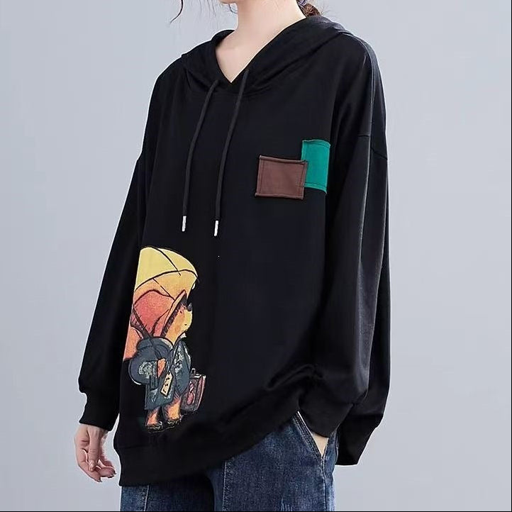 Black pullover hoodie with hood, drawstrings, and front kangaroo pocket; cartoon patch print