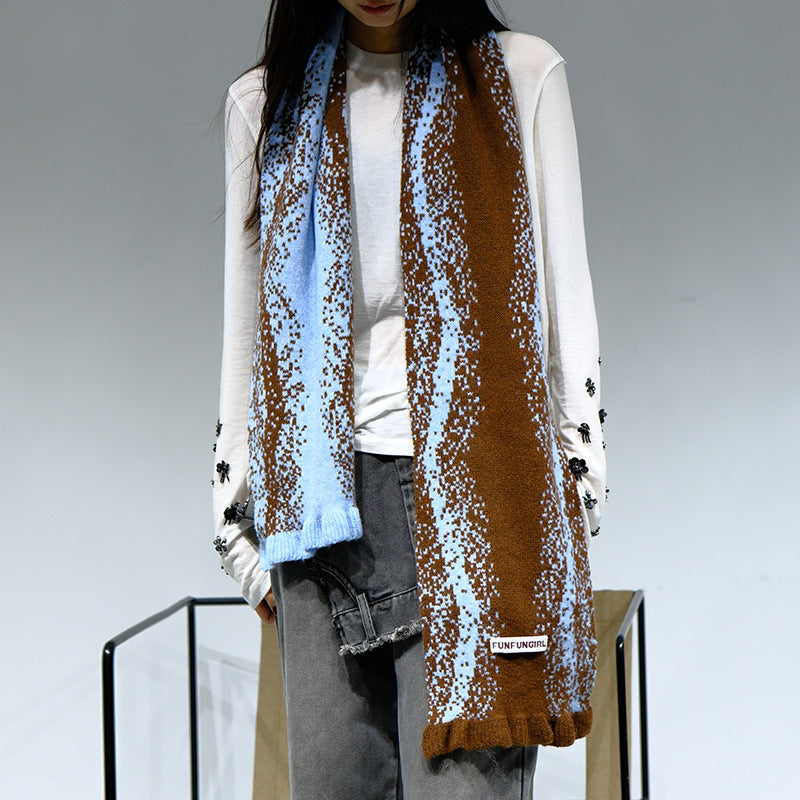 Women's knitted scarf with blue-and-brown speckle pattern and fringed ends