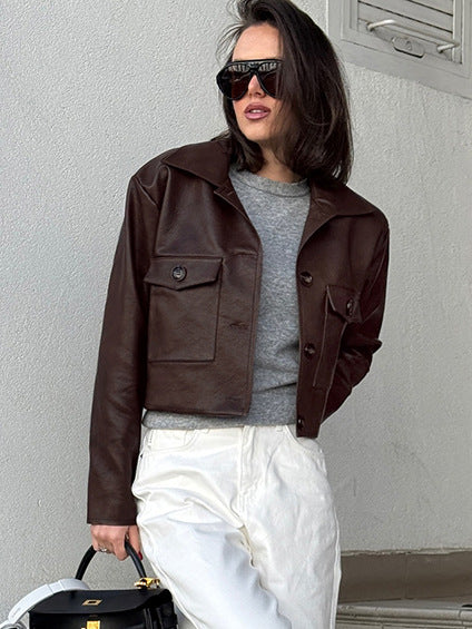 Brown cropped women’s leather jacket with two flap chest pockets and snap buttons