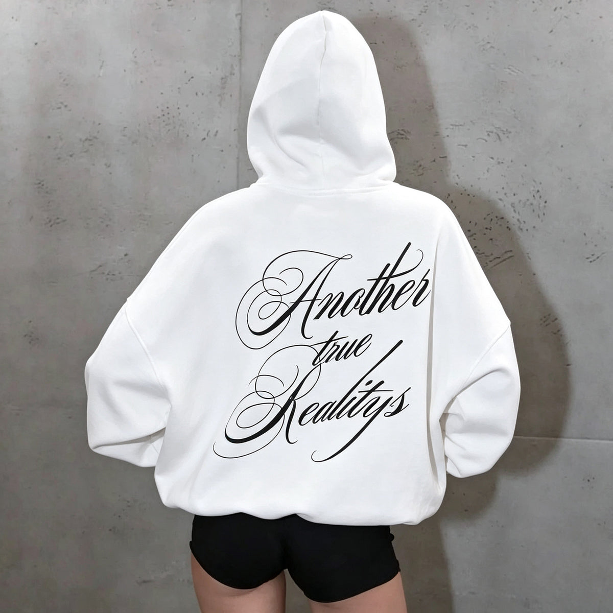 White women's hoodie with large black script lettering across the back