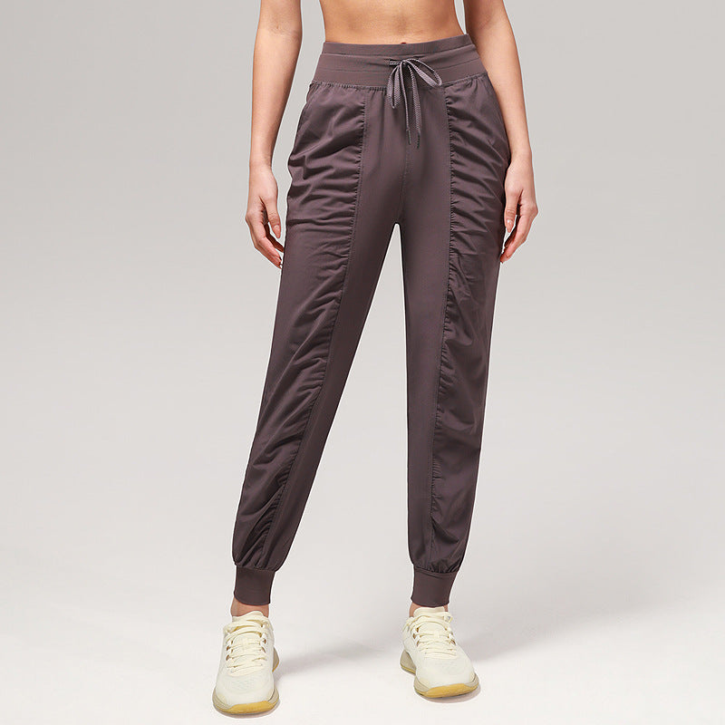 Women’s loose plum purple jogger pants with drawstring waist and cuffed ankles, side pockets.