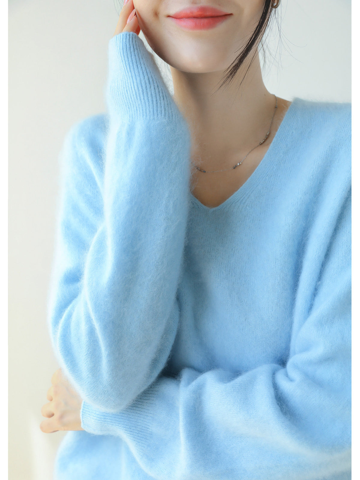 Light blue women's V-neck brushed knit sweater with soft fuzzy texture