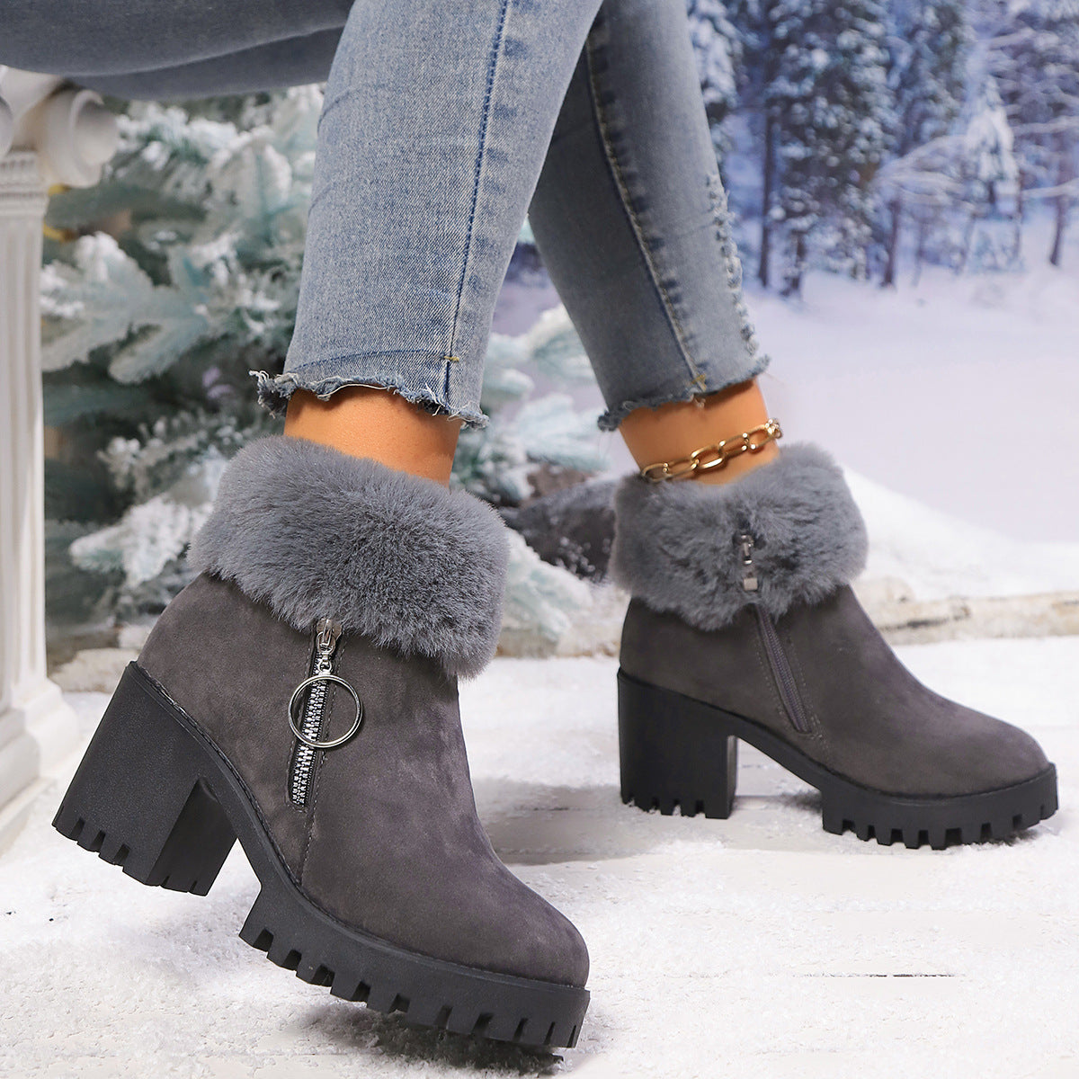 Dark gray suede snow boots with faux fur cuffs, chunky heel, side zipper and ring pull.