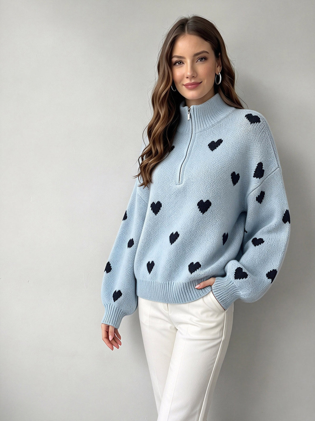 Light blue heart-jacquard sweater with a zip-up high neck and relaxed sleeves.