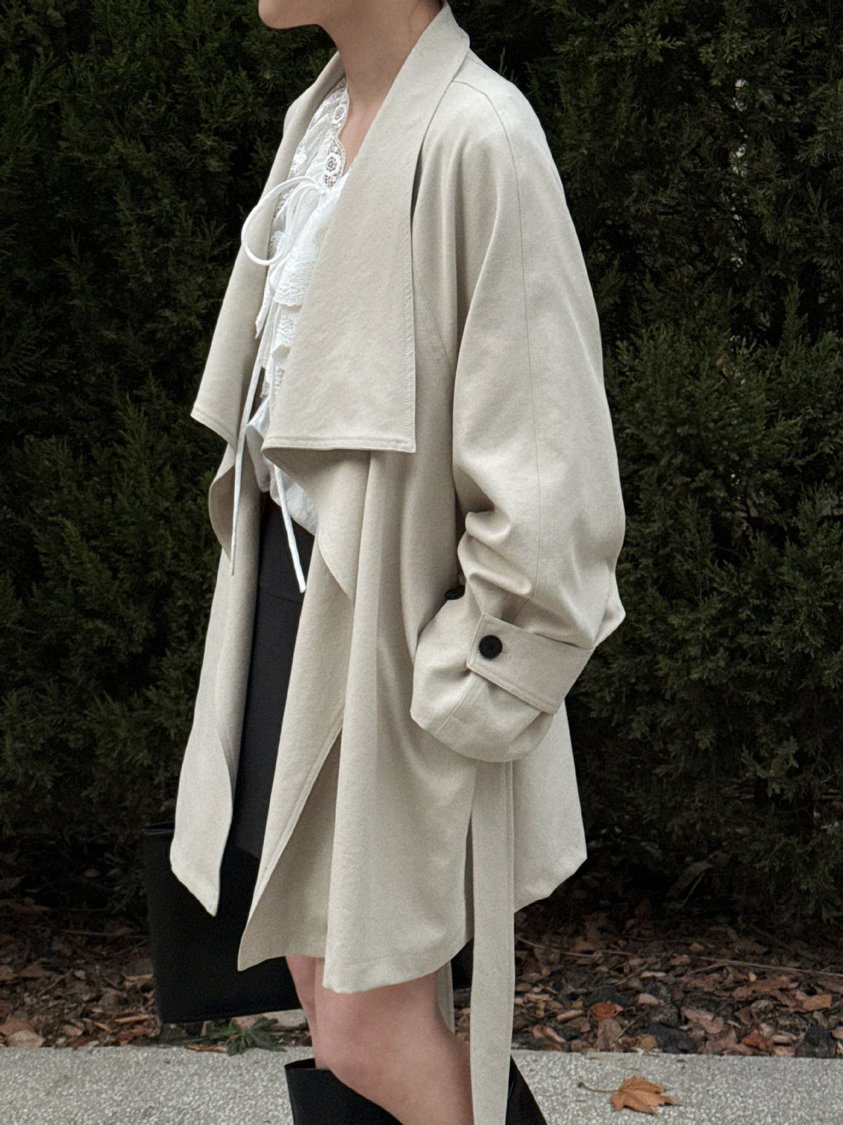 Women’s beige short wrap coat with long sleeves and buttoned cuff details