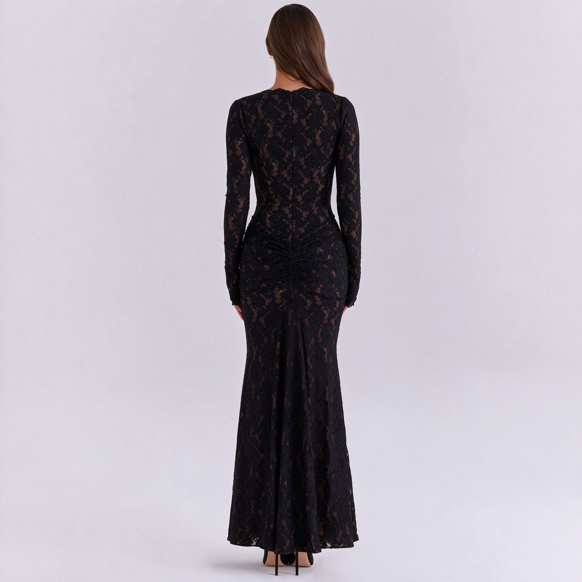 Back view of a black long-sleeve lace maxi dress with a fitted silhouette