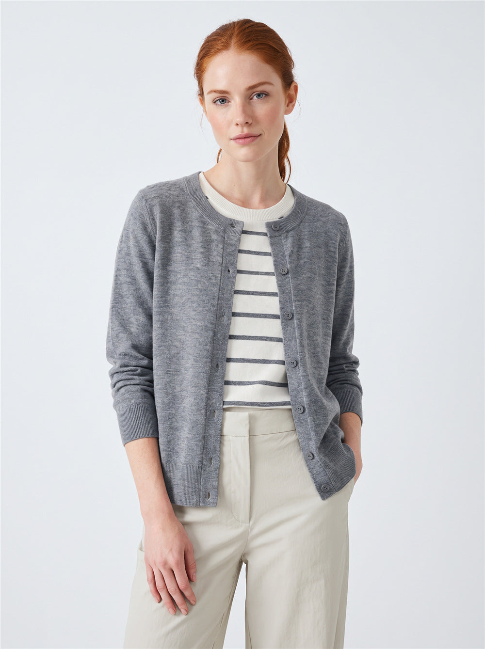 Women’s gray button-front cardigan sweater with faux striped tee underlayer