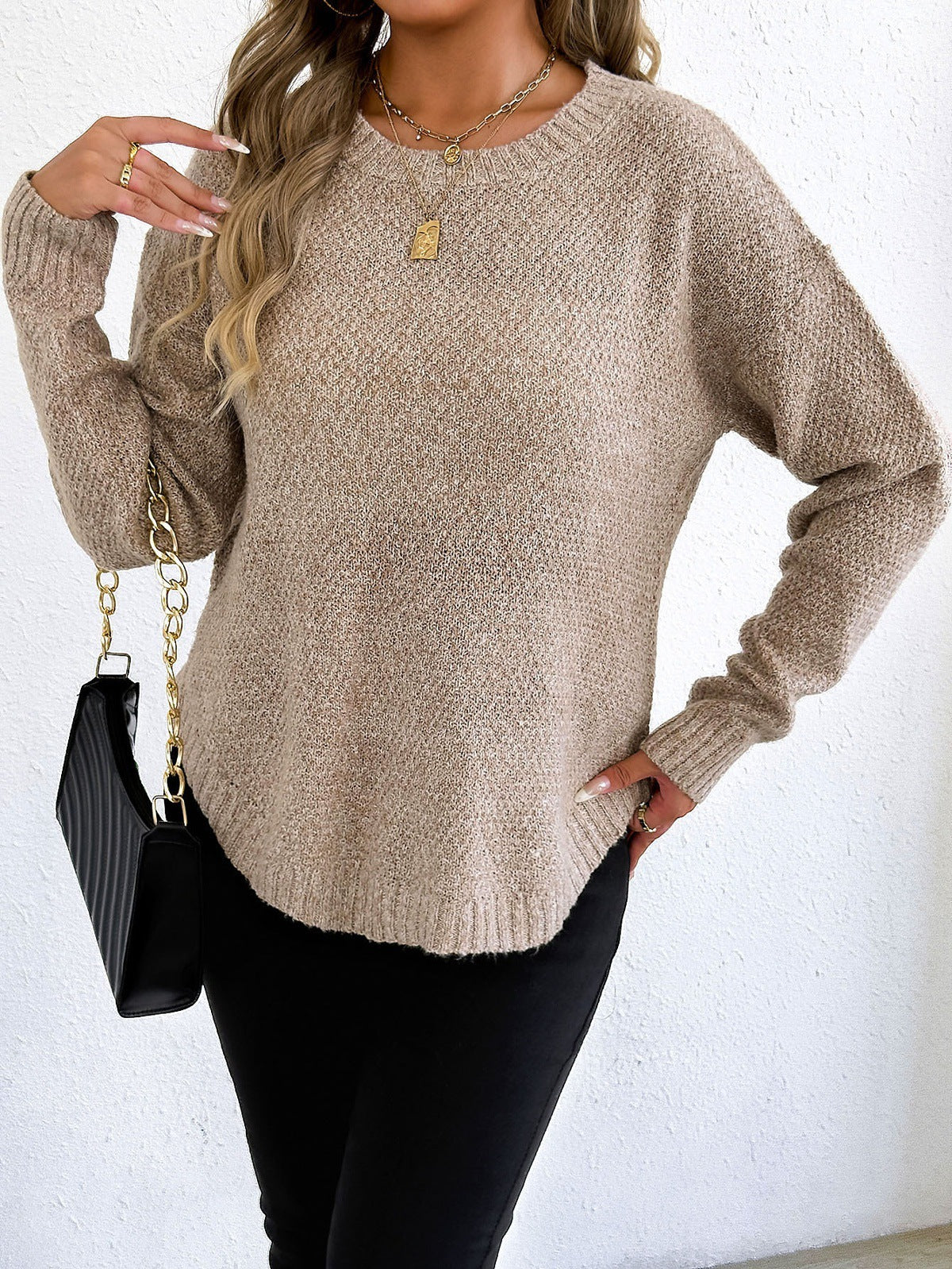 Beige knit pullover sweater with round neckline, long sleeves, textured knit