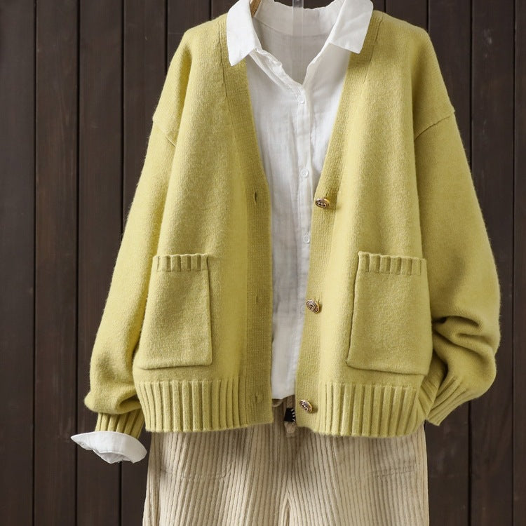 Yellow wool cardigan with V-neck, button front, ribbed cuffs, and patch pockets