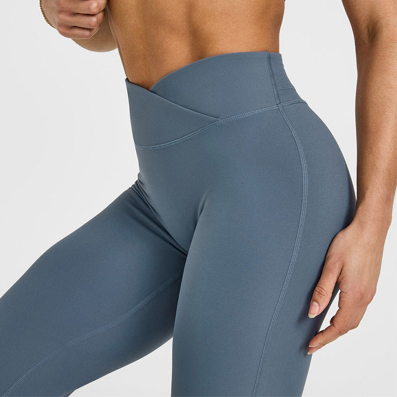 Close-up of women’s slate blue flared yoga pants waistband and sculpting seam lines