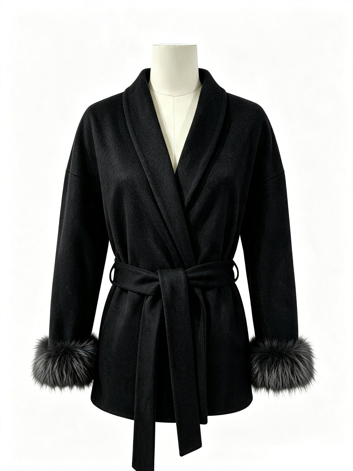 Black wool wrap coat on mannequin with tie belt, turn-down collar, and faux fur cuffs.