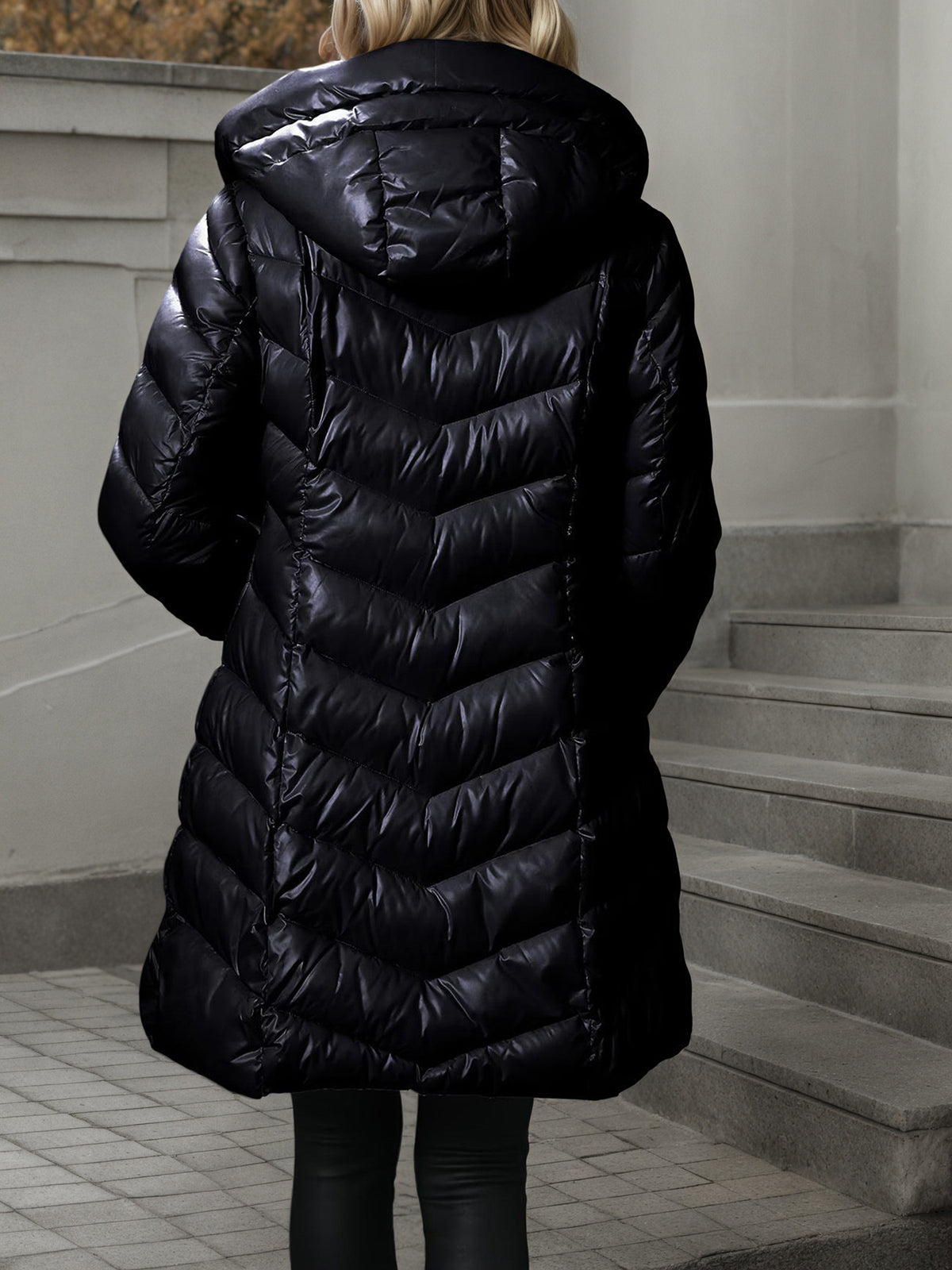 Women's long black quilted puffer coat with hood, full back view