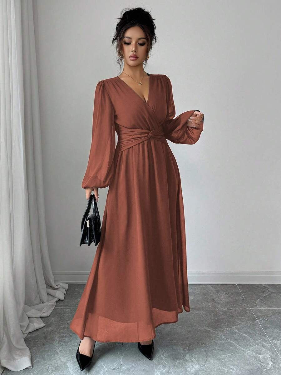 Rust orange chiffon maxi dress with long sleeves, wrap front, cinched waist.