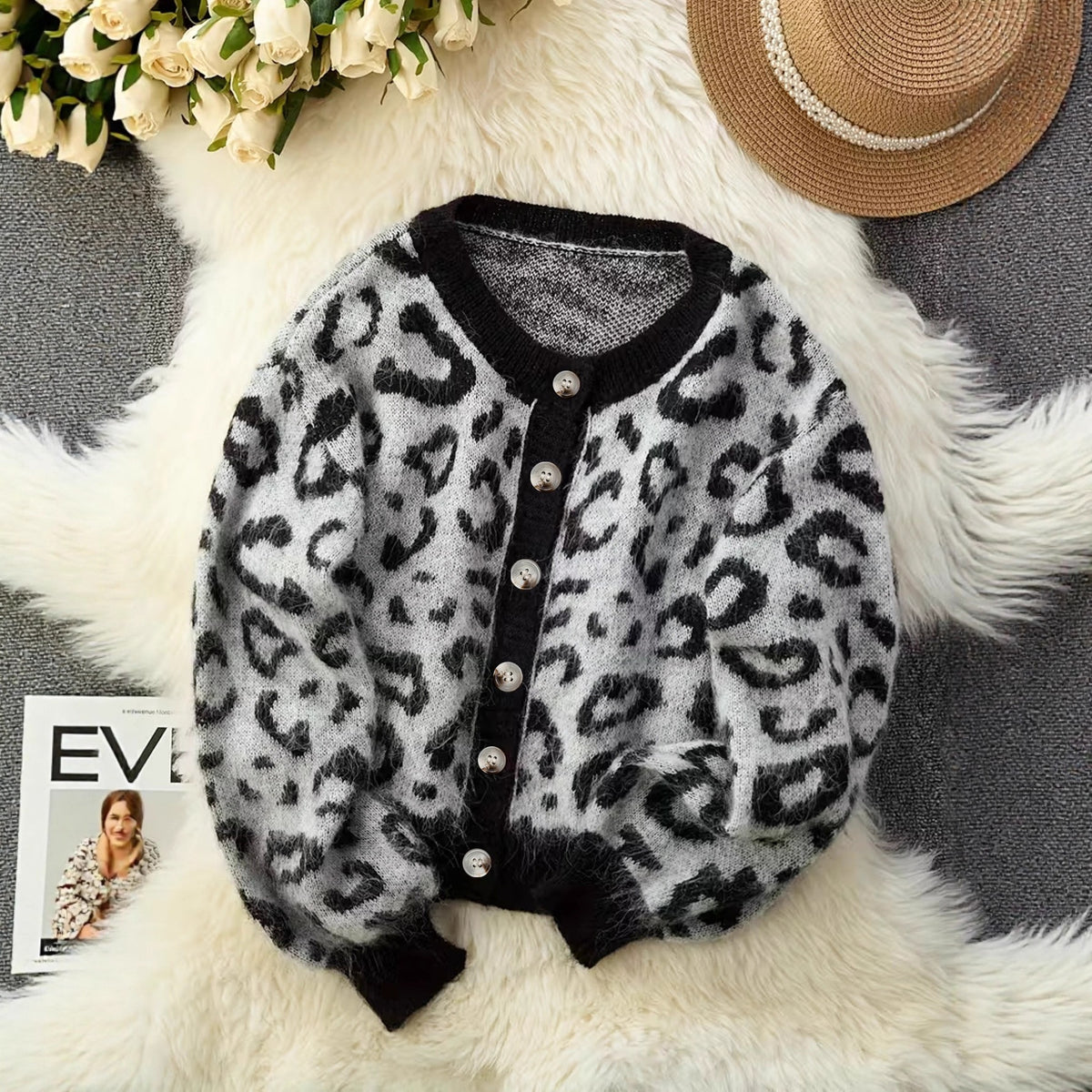 Leopard print knit cardigan with dark trim and button front, close-up detail
