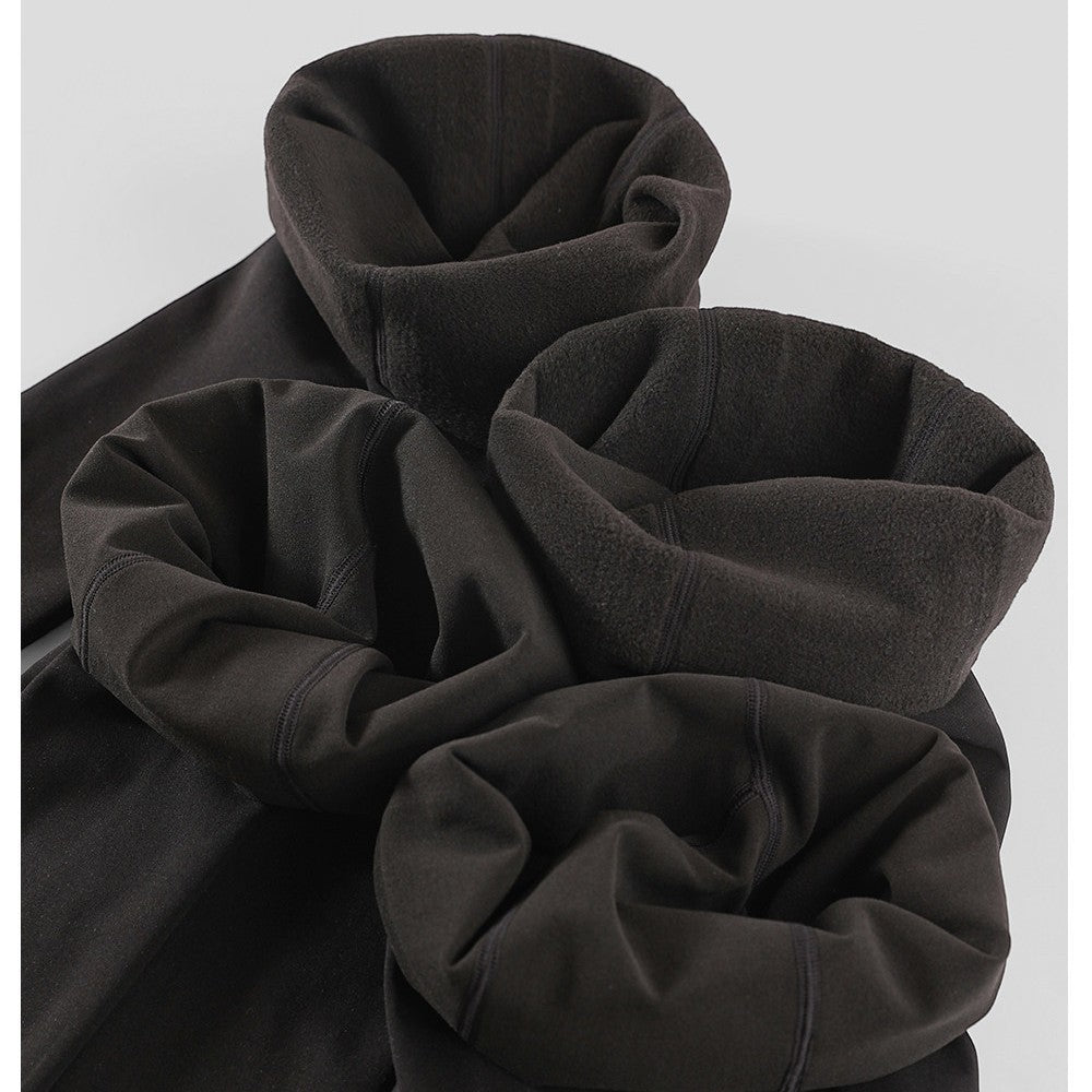 Fleece-lined velvet pantyhose fabric, dark charcoal-black folded for display