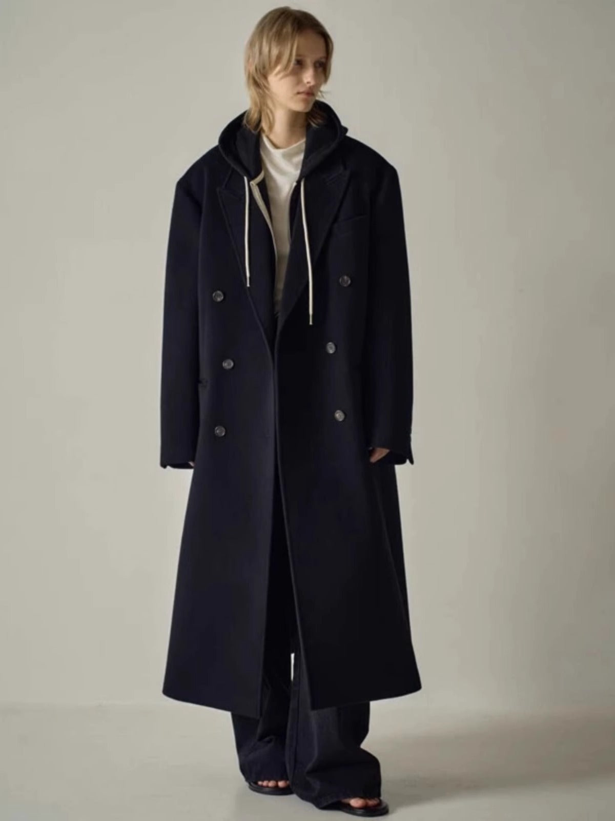 Navy long wool coat with hood, double-breasted front and metal button details