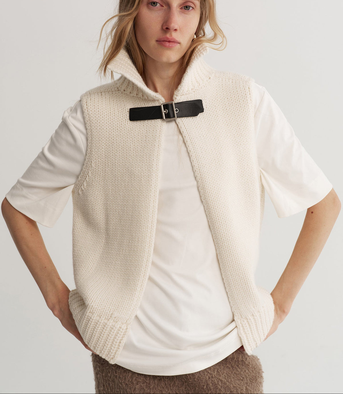 Apricot reversible wool knit vest with stand-up collar and black snap closure