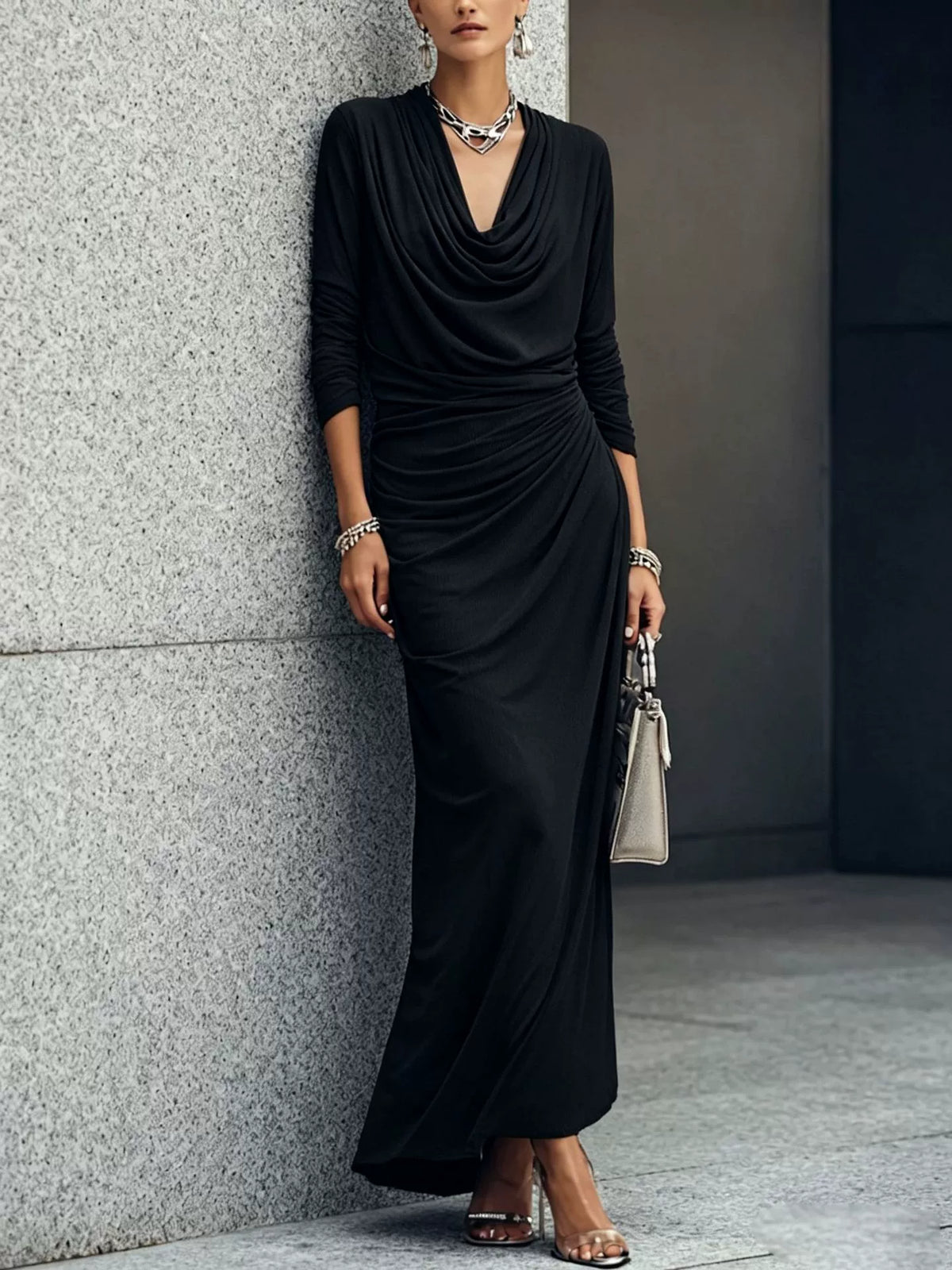 Black long-sleeve draped maxi dress with plunging V-neck and gathered waist
