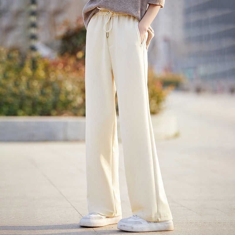 Women’s off-white wide-leg pants with elastic waist ties and drapey straight-leg design