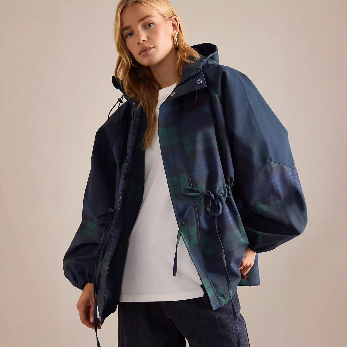 Dark blue hooded windbreaker jacket with stand collar and green plaid tie waist