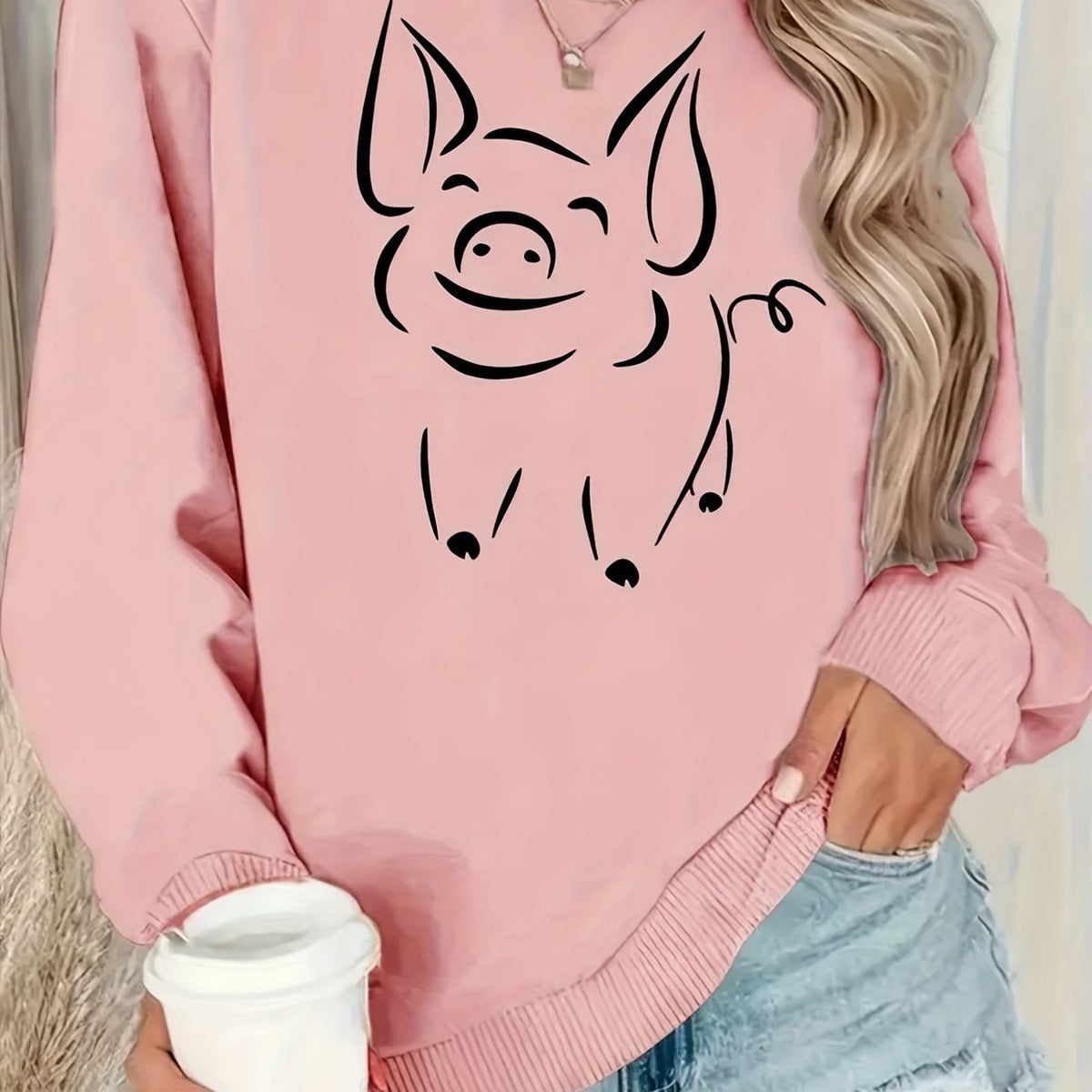 Pink women’s pullover hoodie with smiling cat face front graphic