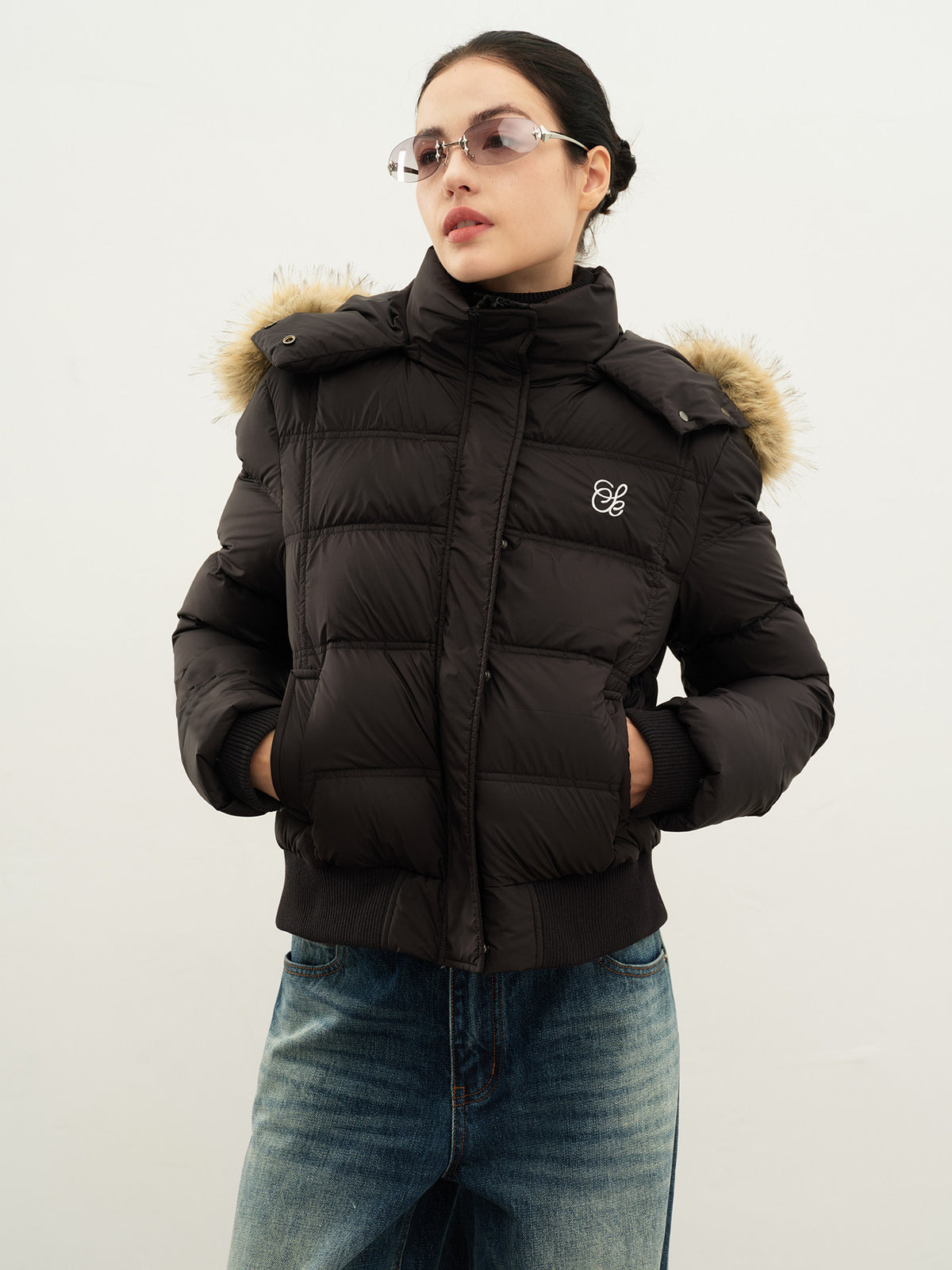 Women's black hooded puffer jacket with faux-fur trim, zip front, quilted design