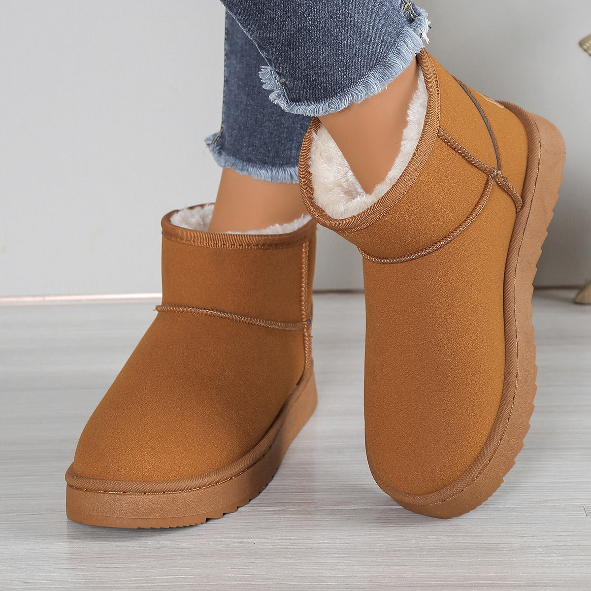 Fleece-lined snow boots in tan suede with white faux-fur lining and chunky sole