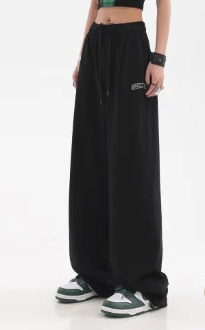 Black wide-leg fleece-lined pants with high elastic waistband and draped front