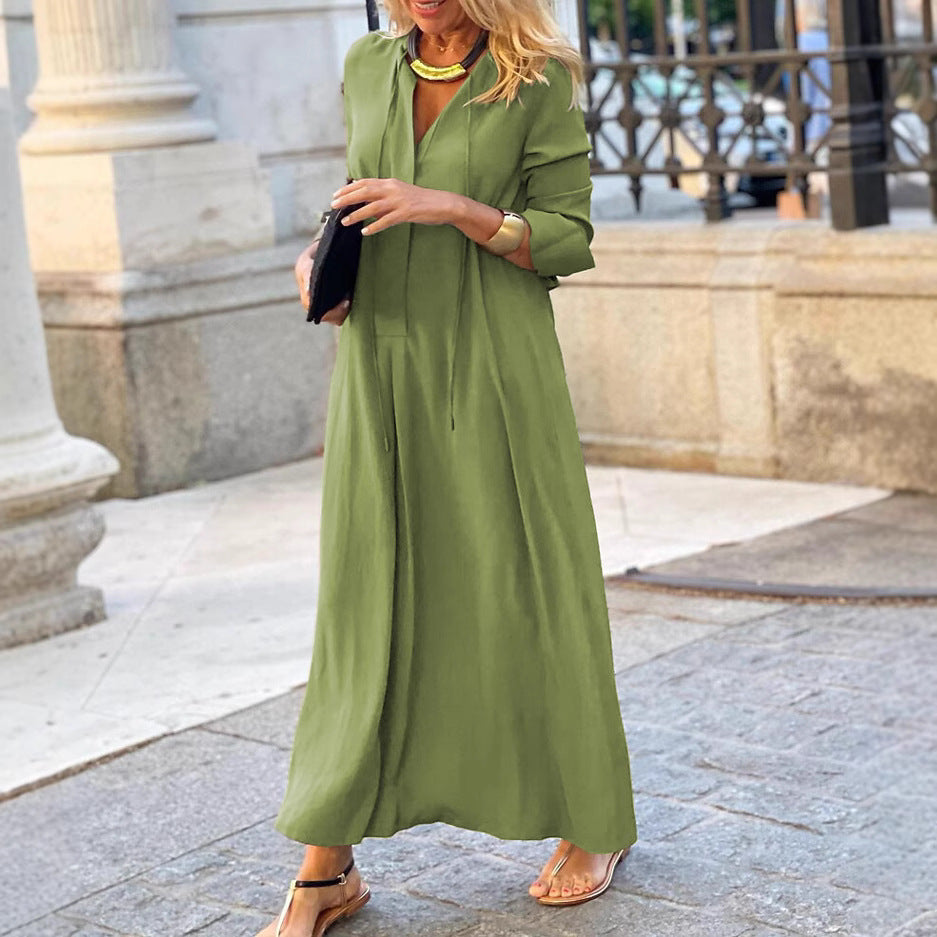 Green linen maxi dress with long sleeves, V-neck, cinched waist and full skirt