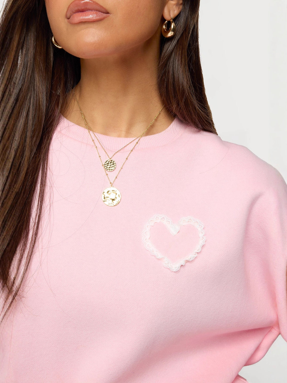Pink sweatshirt with lace heart applique