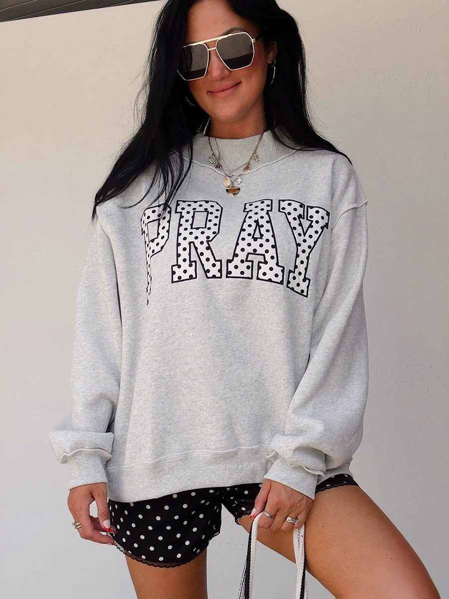 Women's gray raglan sweatshirt with 'PRAY' polka-dot letter graphic, long sleeves