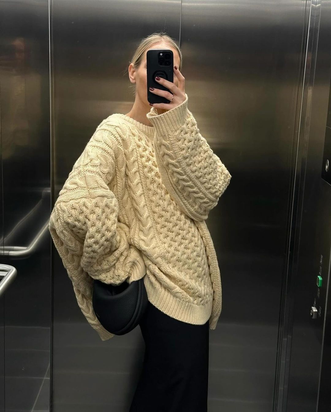 Beige cable-knit turtleneck sweater, relaxed fit, thick cable texture and ribbed cuffs