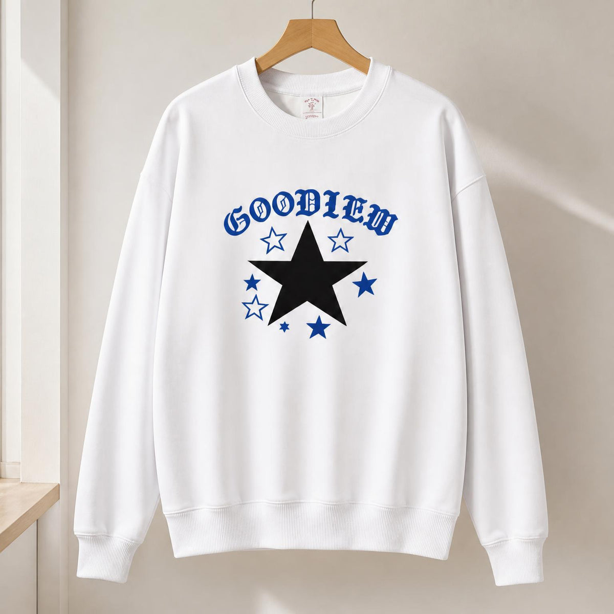 White crewneck sweatshirt with large blue star logo print across front, long sleeves