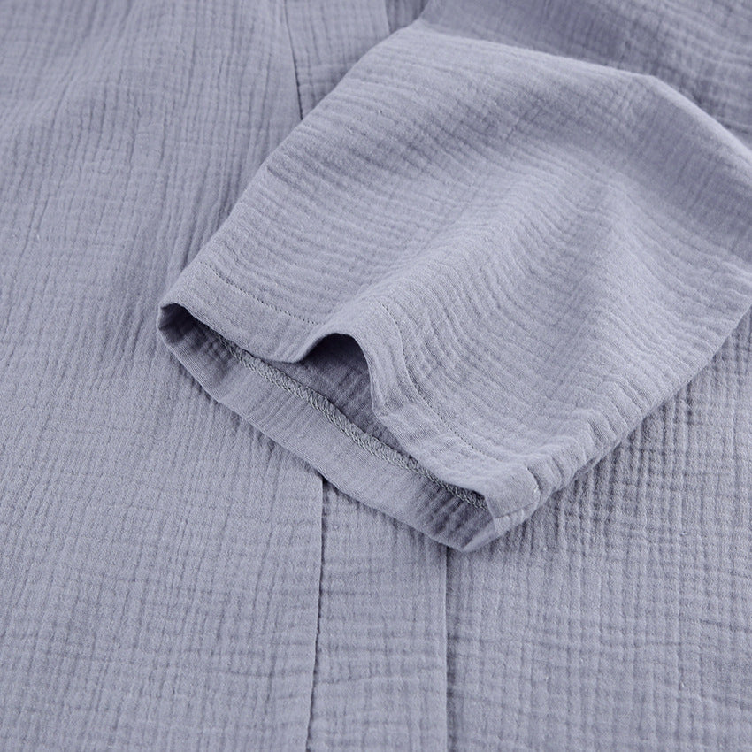 Grey gauze robe sleeve cuff detail with soft rolled hem and textured fabric