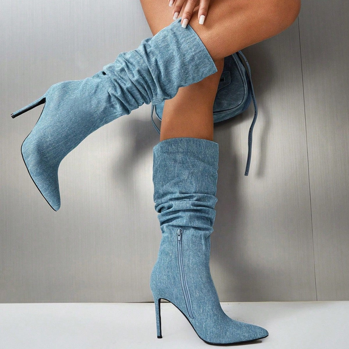 Blue suede over-the-knee boots with ruched cuff, pointed toe, stiletto heel, tie detail
