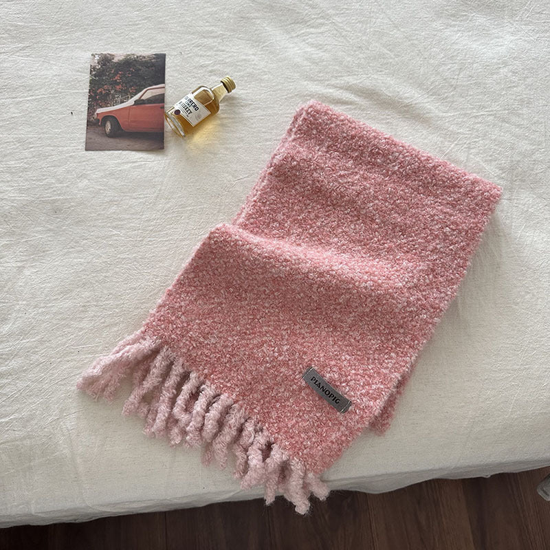 Folded pink chunky loop-knit scarf shawl with soft fringe ends and small label
