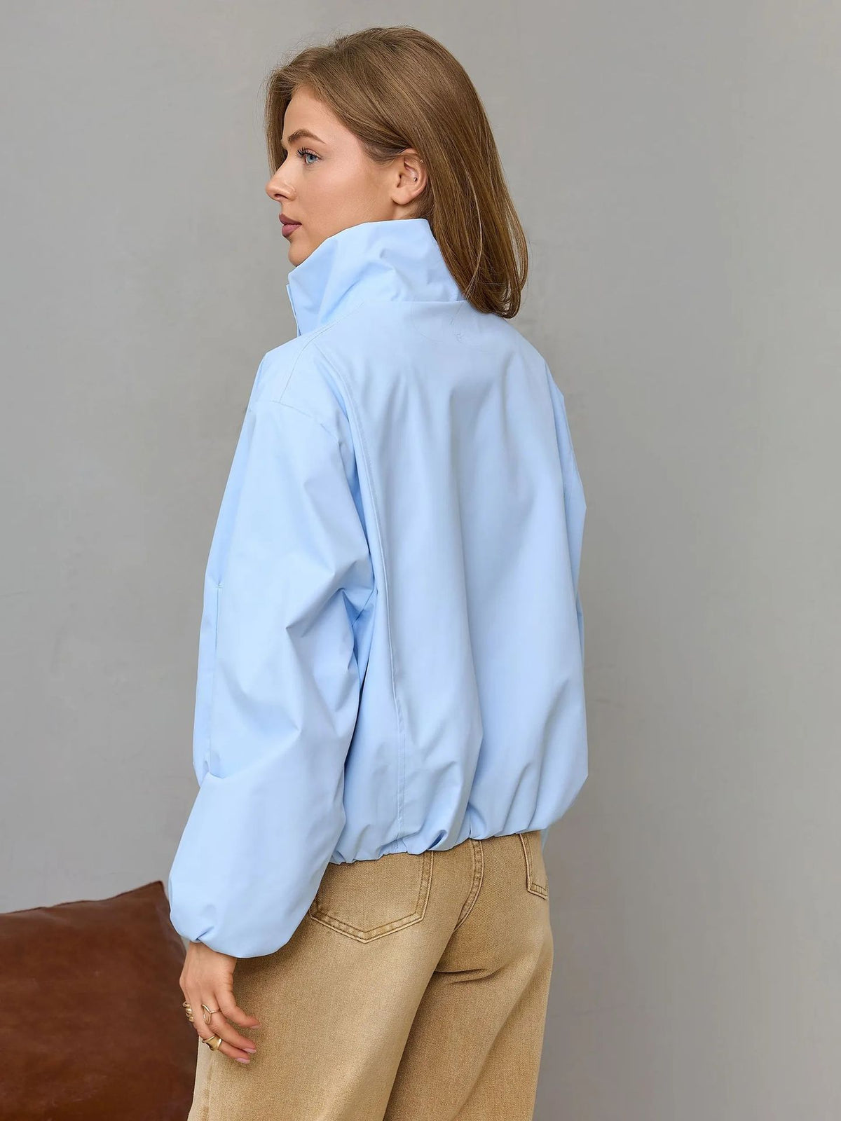 Light blue women’s short casual jacket shown from the back with stand collar