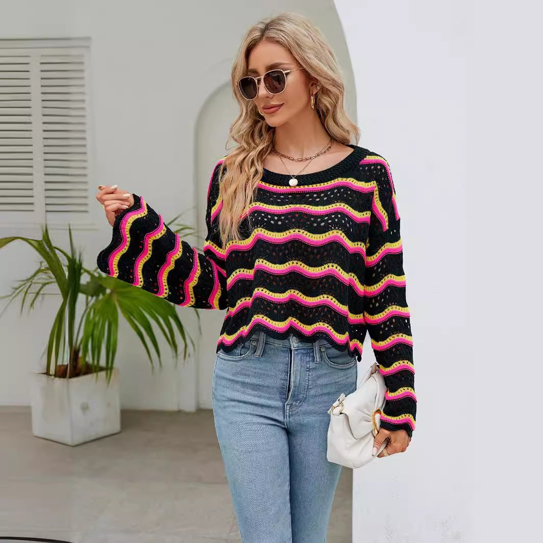 Women’s striped knit pullover sweater with long sleeves, crew neck; black with pink and yellow wavy stripes