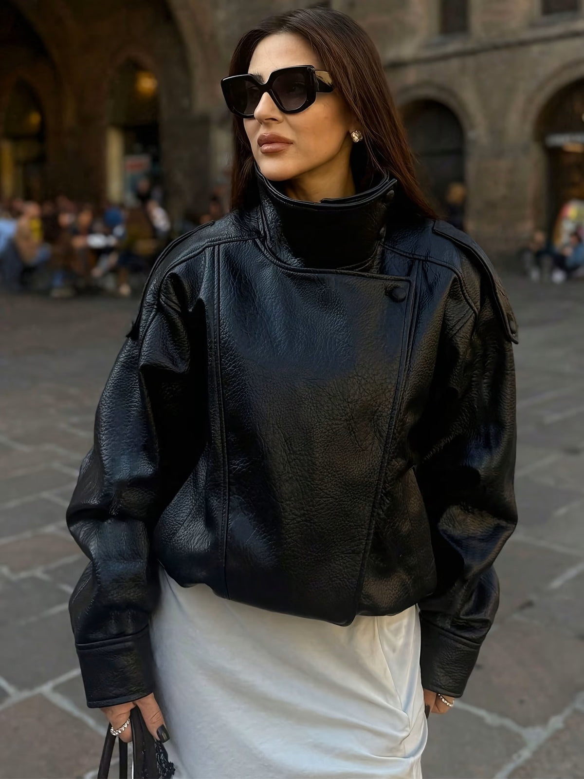 Black faux leather moto jacket with high neck and asymmetric zip front