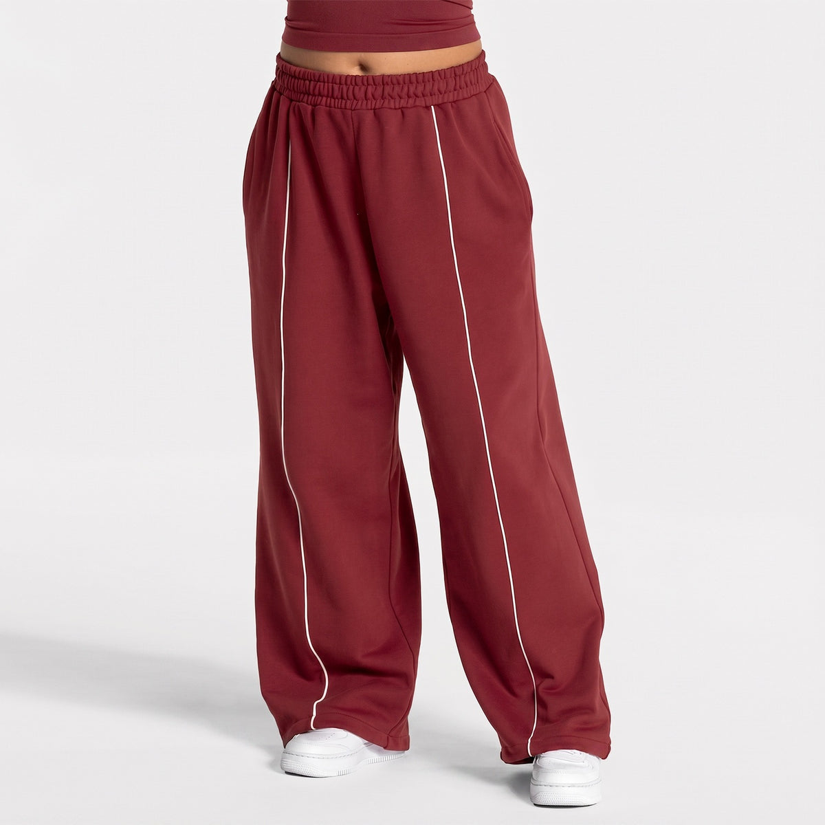Wine red loose yoga pants with elastic waistband and vertical white contrast stripe