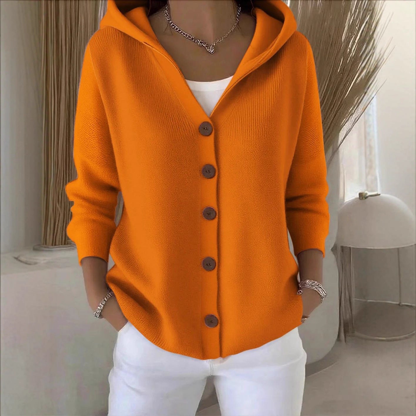 Orange hooded knit cardigan with button-front placket and long sleeves