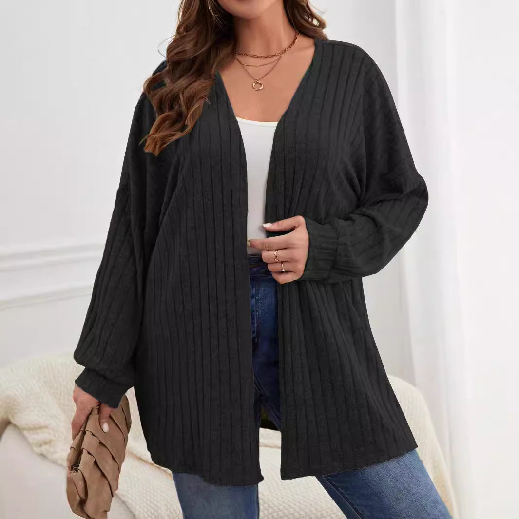 Black plus-size knitted long-sleeve jacket with ribbed texture, open front, mid-length.