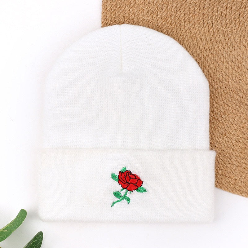 White knit beanie with red rose embroidery